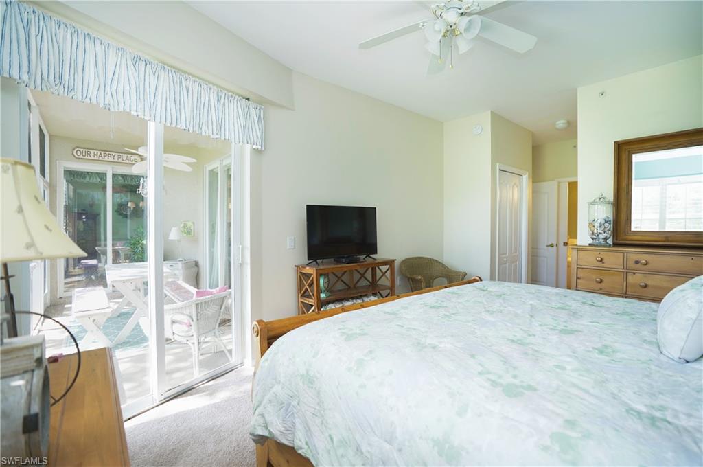 Carpeted bedroom featuring ceiling fan, a closet, and access to exterior