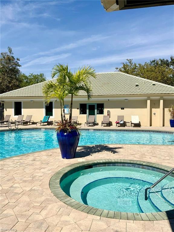 View of swimming pool with a patio and an in ground hot tub