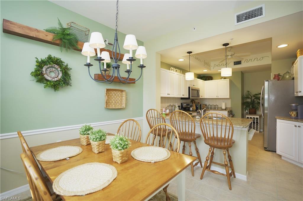 Dining area featuring a notable chandelier and light tile patterned floors