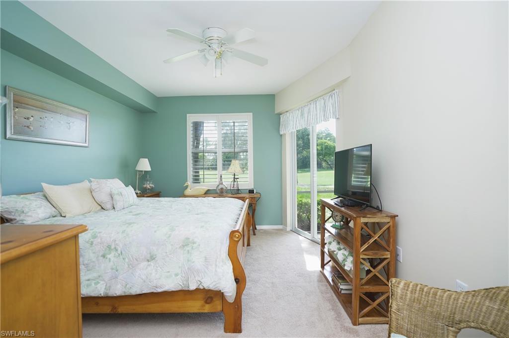 Carpeted bedroom featuring ceiling fan and access to outside