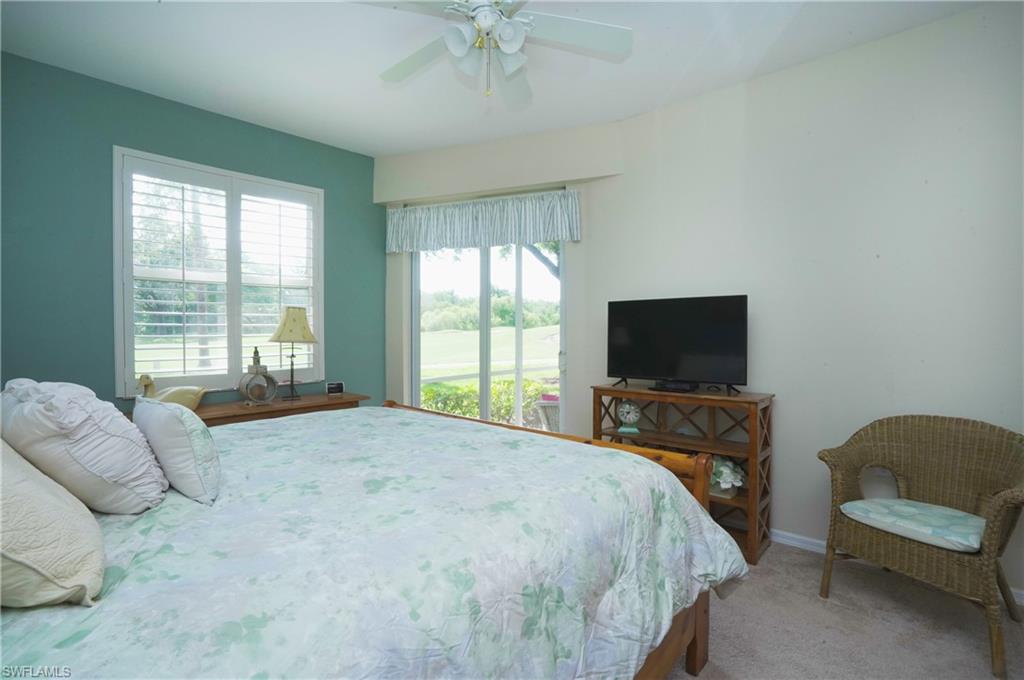 Bedroom featuring ceiling fan and carpet