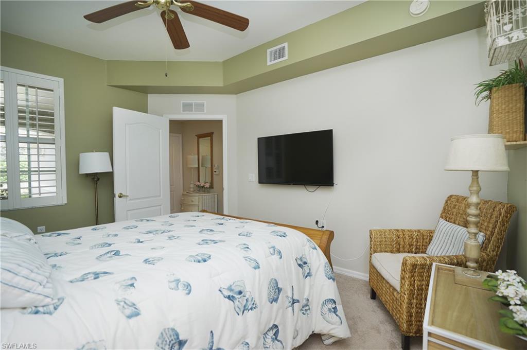 Bedroom featuring light carpet and ceiling fan