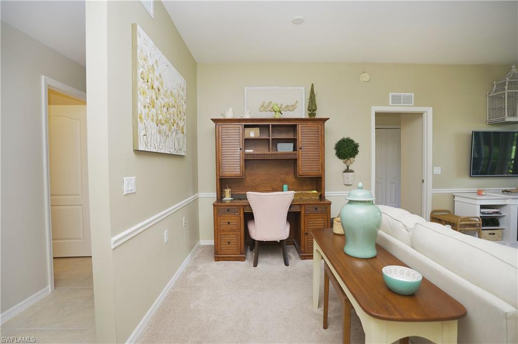 Office area featuring light carpet