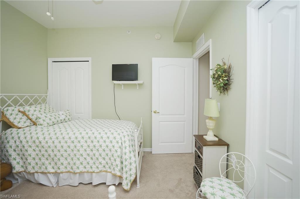 Bedroom with a closet and light carpet