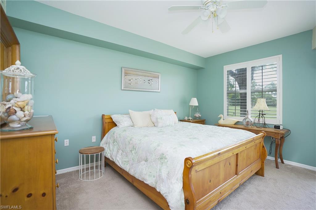 Bedroom with ceiling fan and light colored carpet