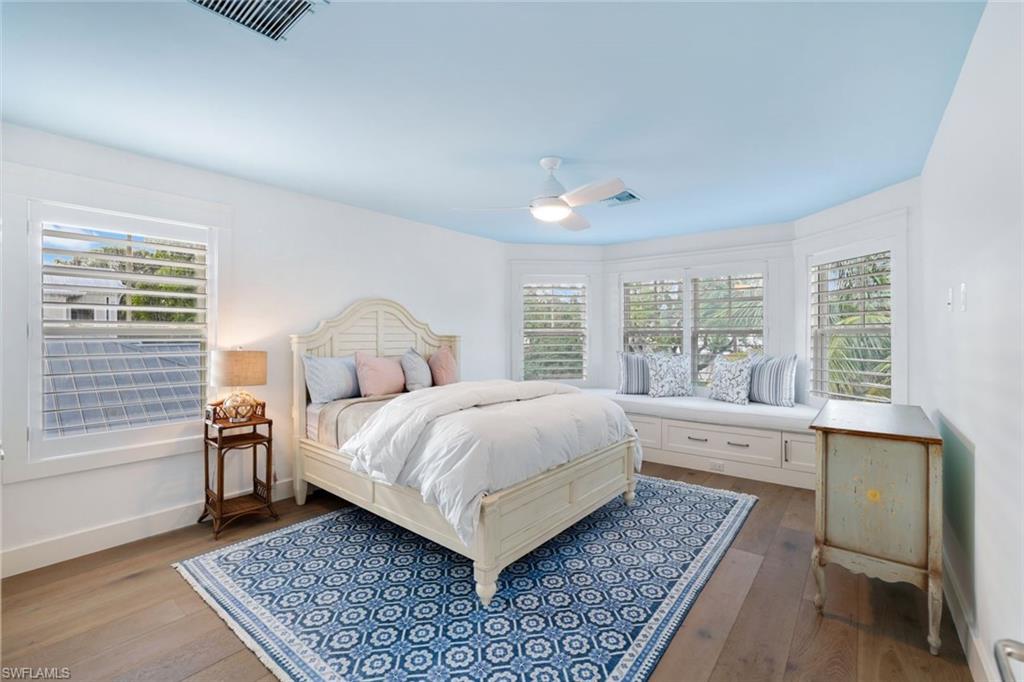 Bedroom with light hardwood / wood-style flooring and ceiling fan