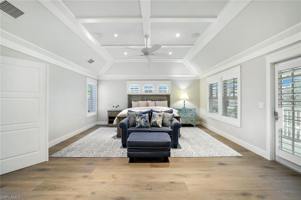 Bedroom featuring access to exterior, light hardwood / wood-style floors, and multiple windows