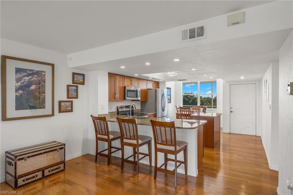 Kitchen area featuring wood-finish flooring and recessed lighting