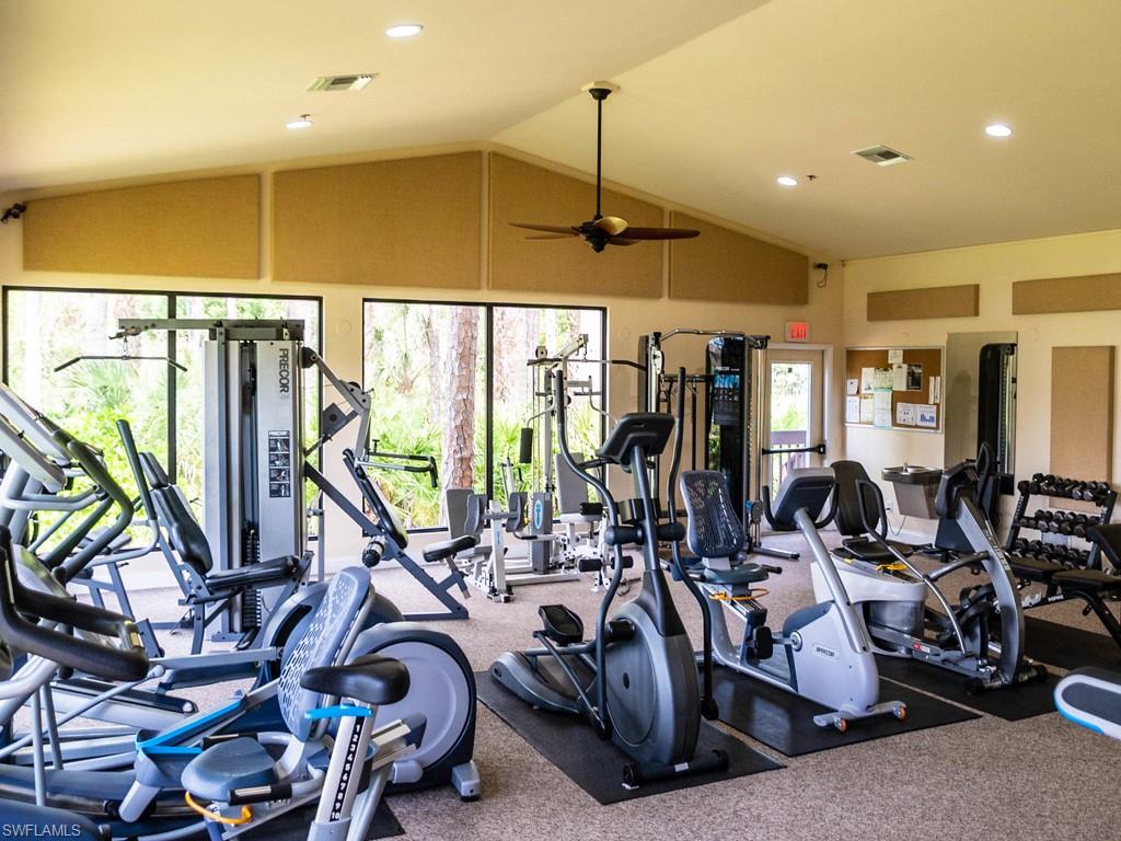 Fitness center featuring a vaulted ceiling with a ceiling fan and recessed lighting