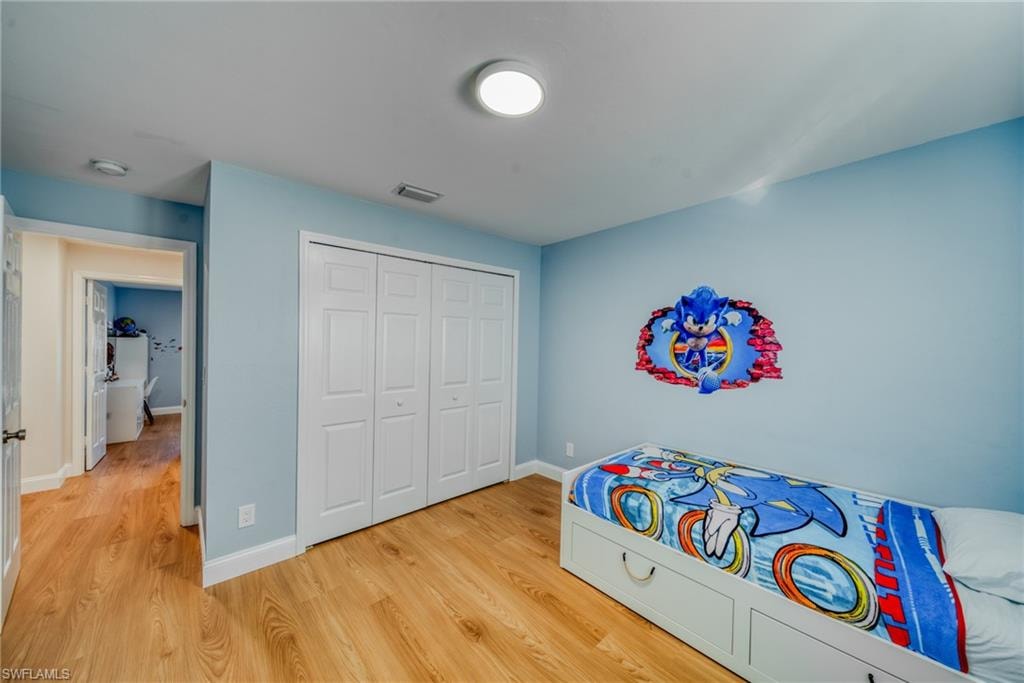 Bedroom featuring light wood-style flooring and a closet