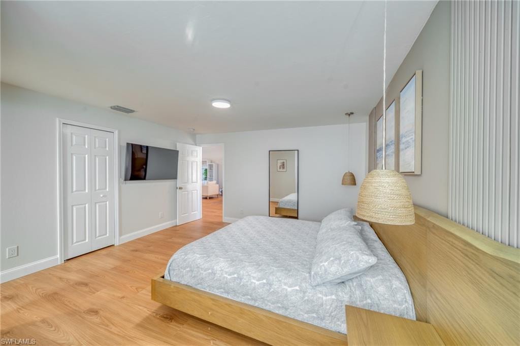 Bedroom featuring light wood-type flooring and baseboards