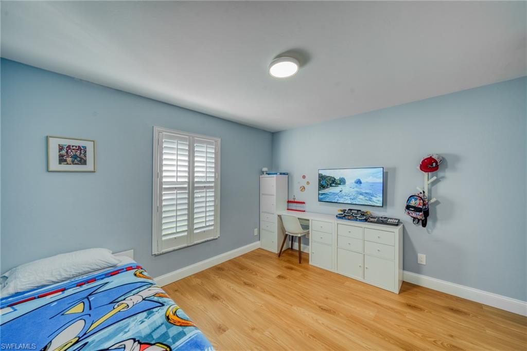 Bedroom featuring light wood-type flooring and baseboards