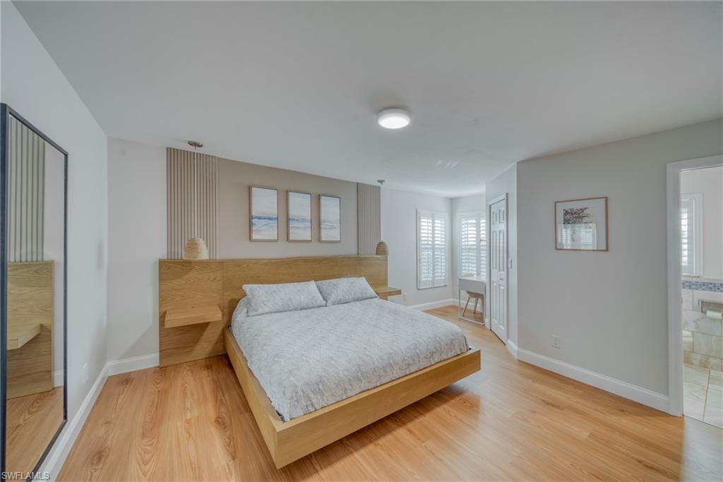 Bedroom featuring light wood-type flooring and a closet
