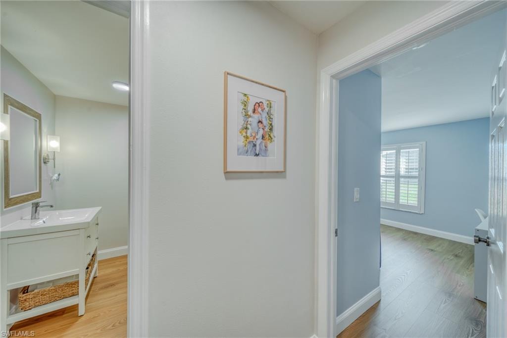 Hallway with light wood-style floors