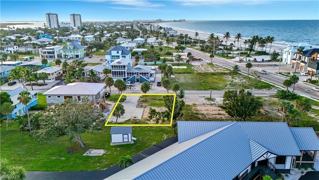 Aerial overview of property's location featuring property boundaries highlighted and a large body of water - Virtually Edited Image