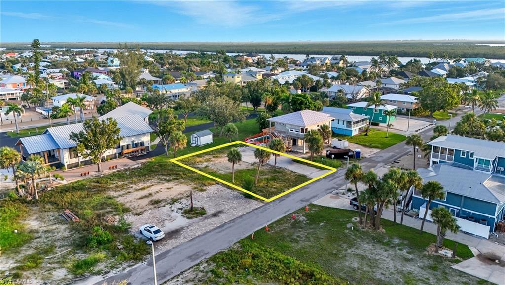 Aerial view of residential area featuring property parcel outlined - Virtually Edited Image
