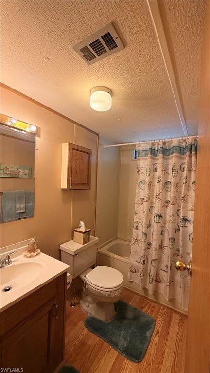 Guest Bathroom featuring wood-look flooring, a vanity with storage, a wall-mounted medicine cabinet, and a built-in bathtub with shower.