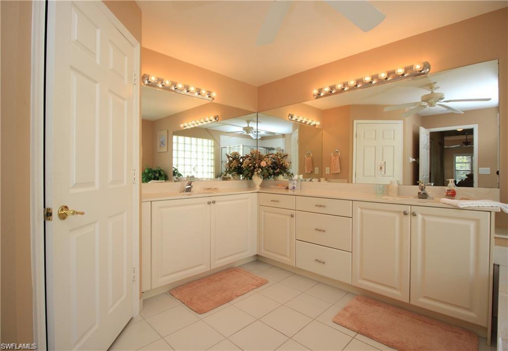 Bathroom featuring a wealth of natural light, vanity, ceiling fan, and tile patterned floors