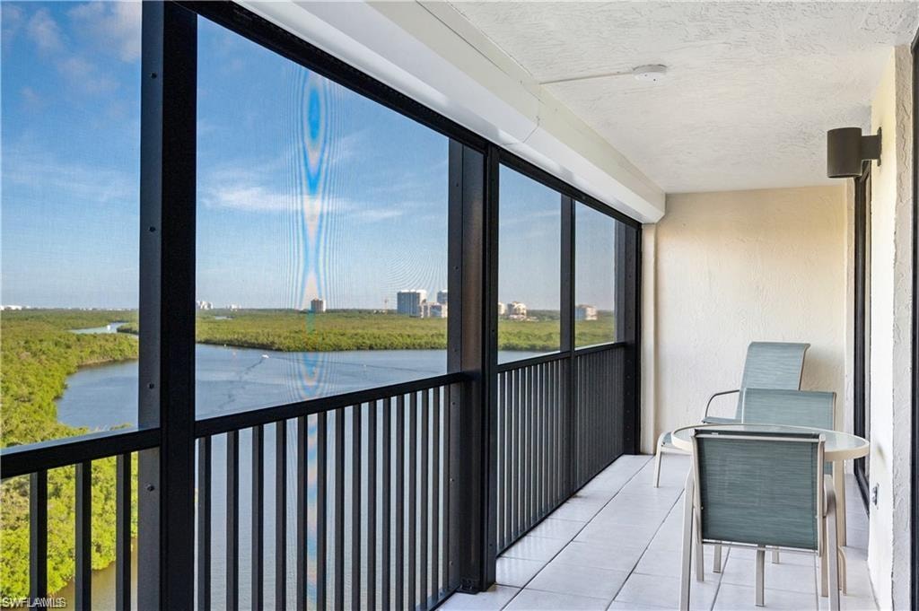 Sunroom featuring a water view