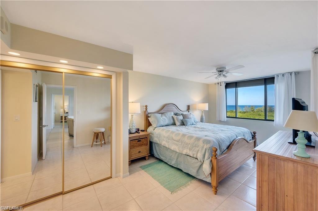 Tiled bedroom featuring a closet and ceiling fan