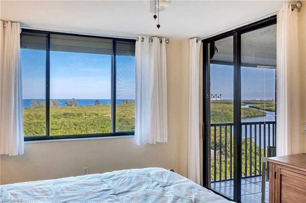 Bedroom with a water view and access to outside