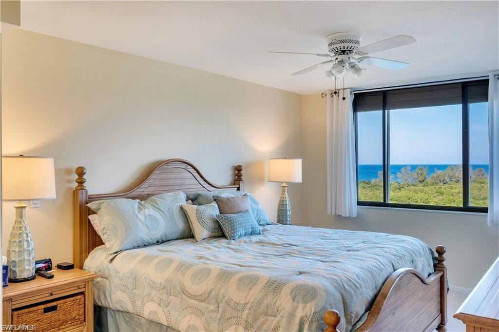 Bedroom featuring a water view and ceiling fan
