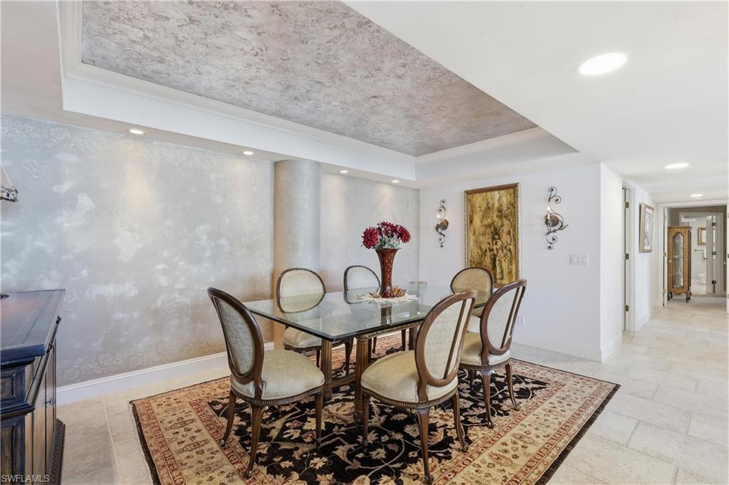 Dining area featuring a recessed ceiling with textured finish and crown molding