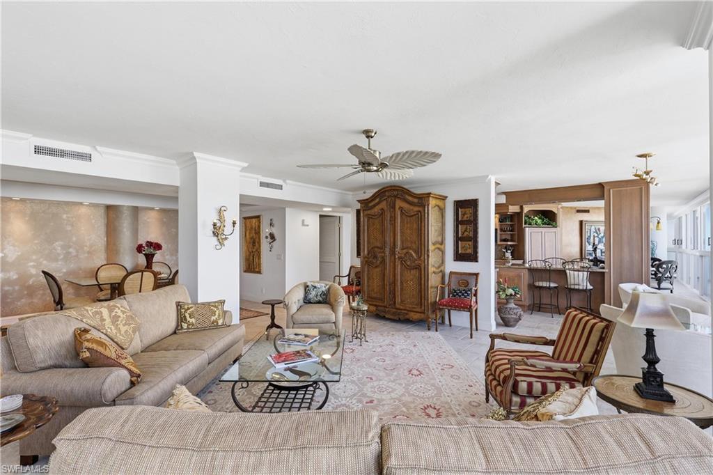 Open concept living area with crown molding, recessed lighting, and a ceiling fan