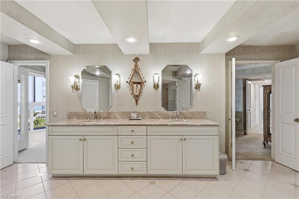 Dual vanity featuring an integrated countertop, under-mount sinks, and individual mirrors