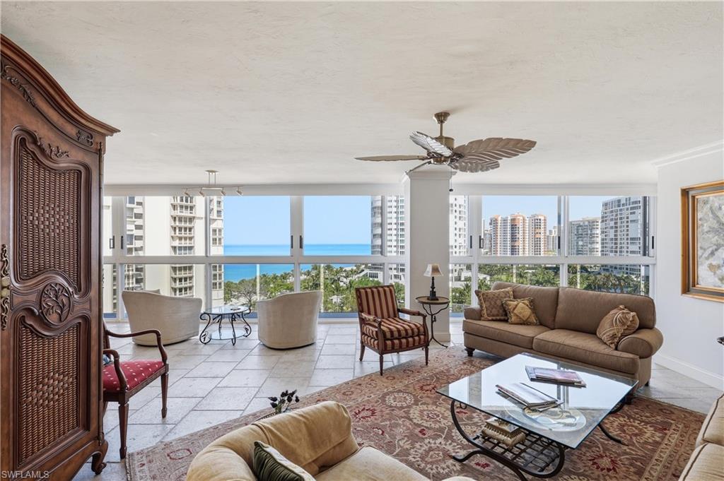 Spacious living area featuring large format tile flooring and extensive window walls