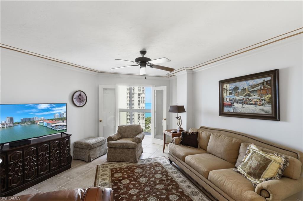 Living area featuring crown molding, a ceiling fan, and tile flooring