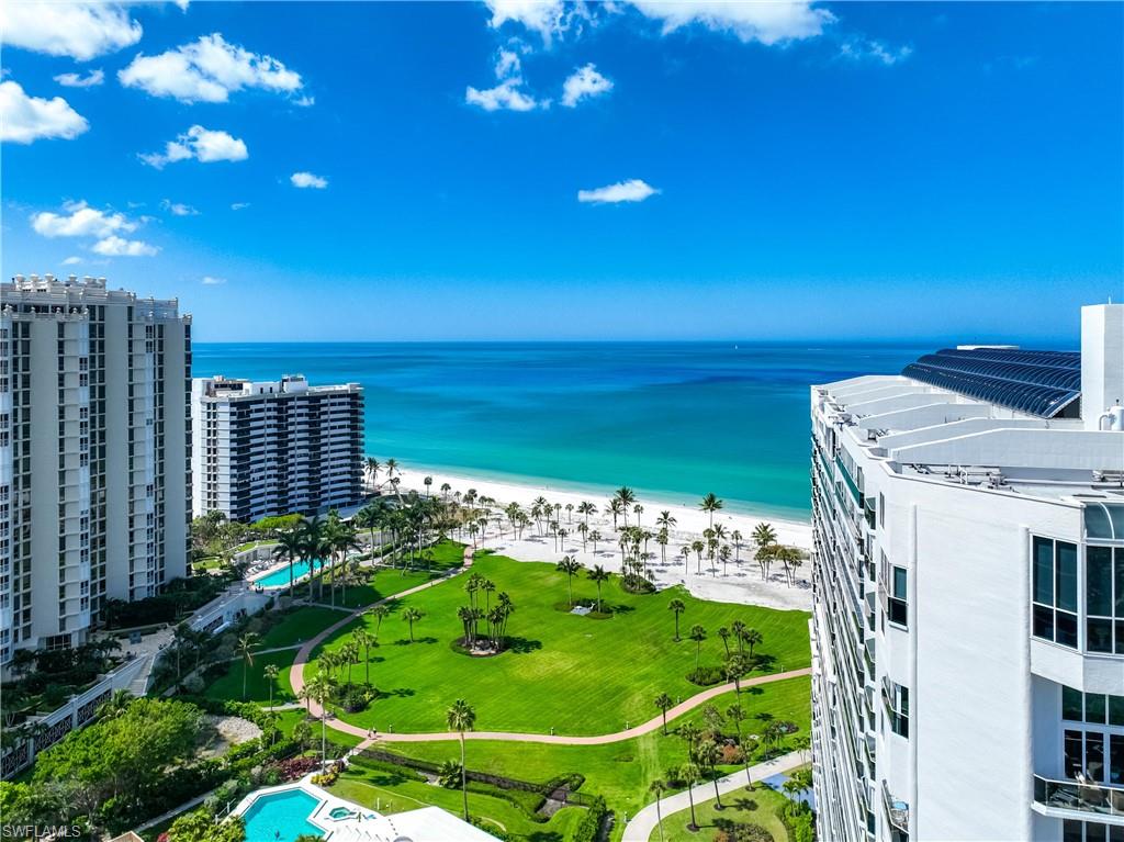 Expansive beachfront setting with white sand and clear blue water