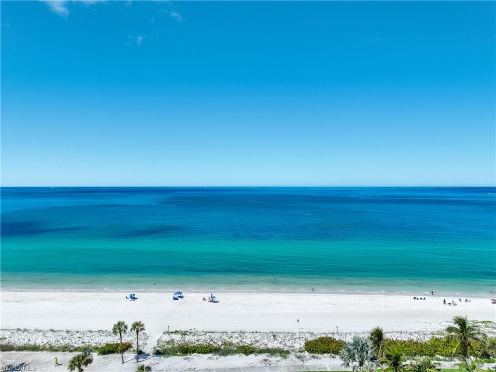 Expansive oceanfront vista featuring white sand beaches and clear blue waters