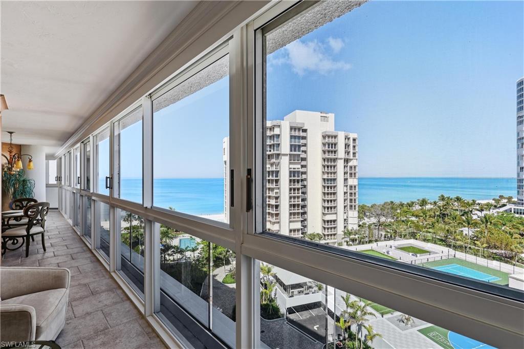 Floor-to-ceiling windows with expansive ocean and beach scenery