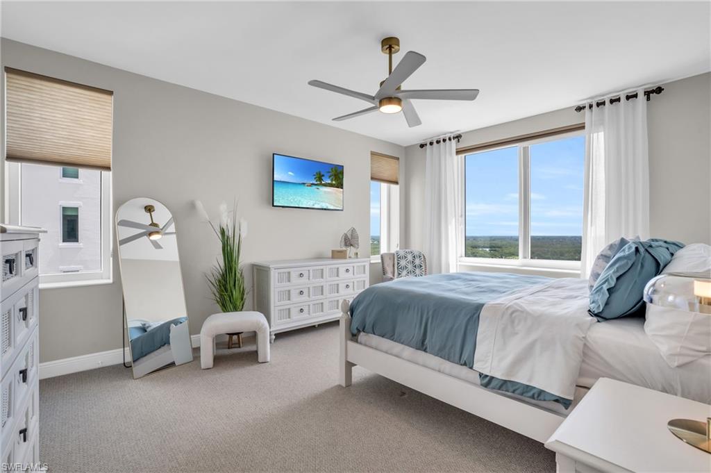 Carpeted bedroom featuring ceiling fan