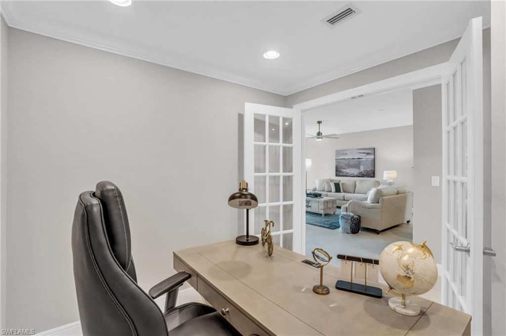 Home office featuring ceiling fan, french doors, and crown molding