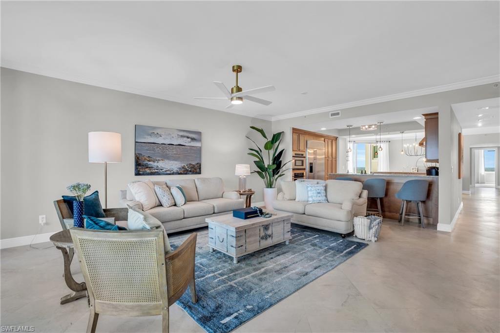 Living room featuring crown molding, plenty of natural light, and ceiling fan