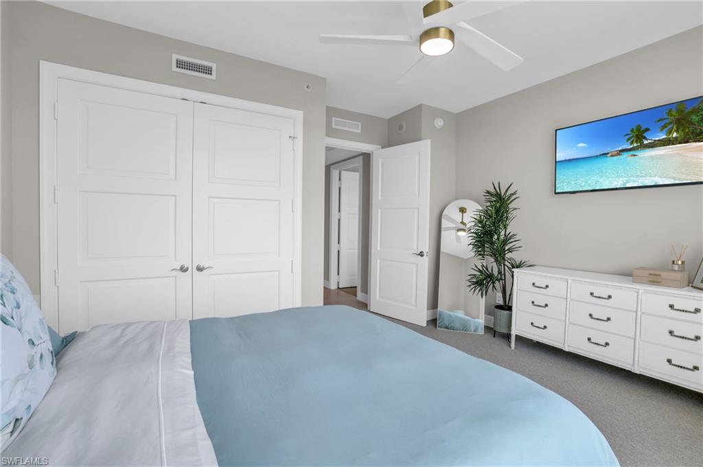 Bedroom featuring ceiling fan, a closet, and dark colored carpet