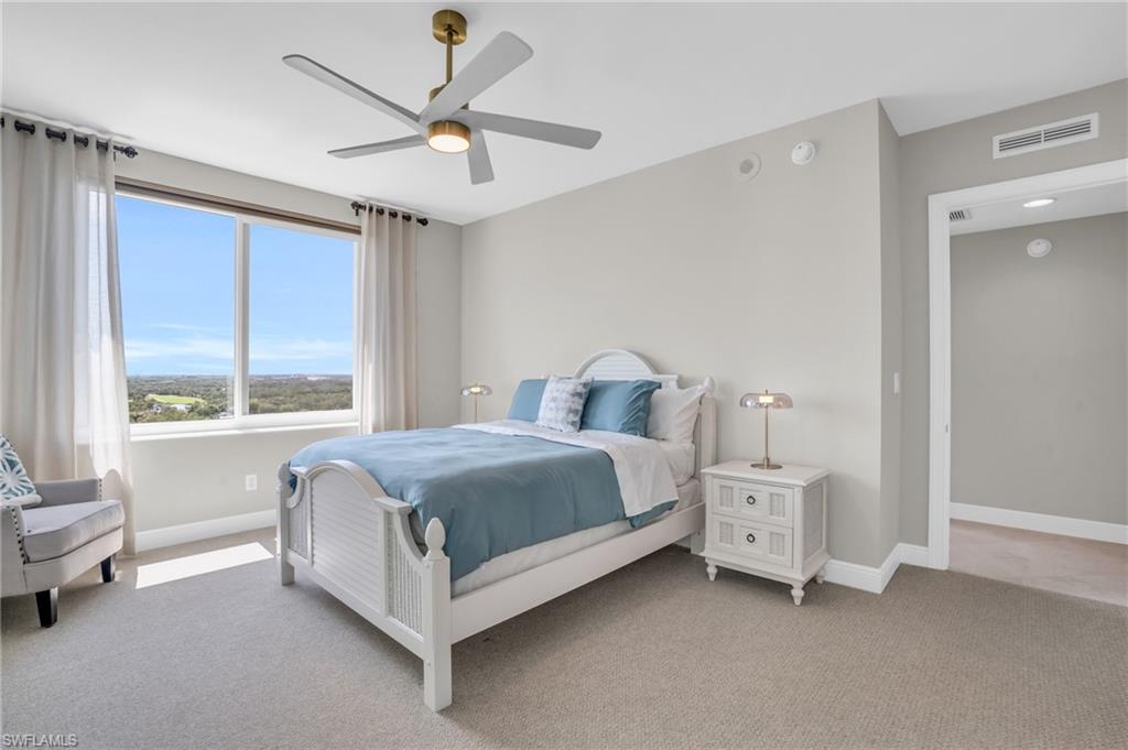 Carpeted bedroom featuring ceiling fan