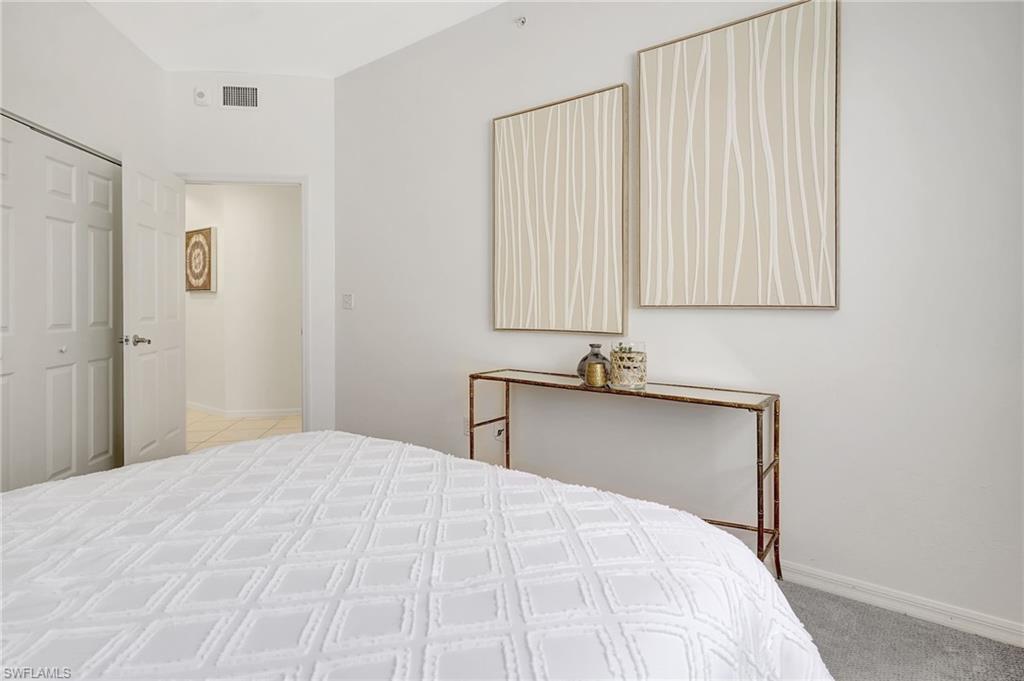 Carpeted bedroom featuring a closet