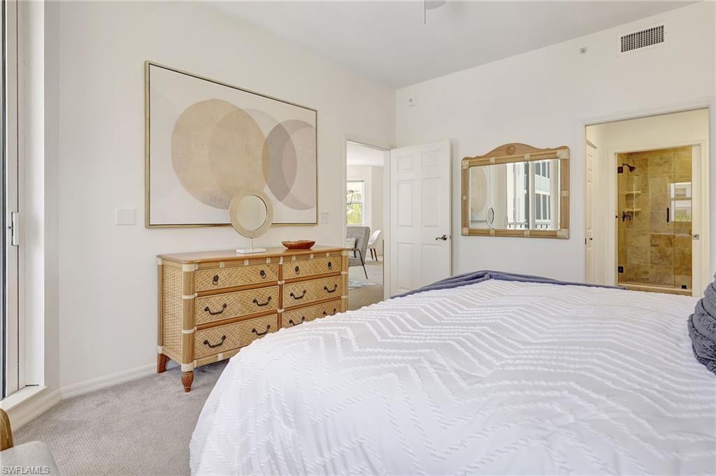 Carpeted bedroom featuring ensuite bath