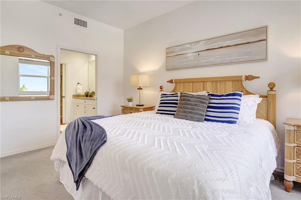 Bedroom featuring carpet flooring and ensuite bathroom
