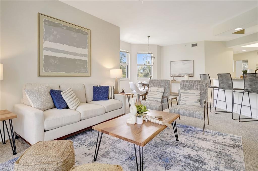 Living room featuring a notable chandelier and carpet