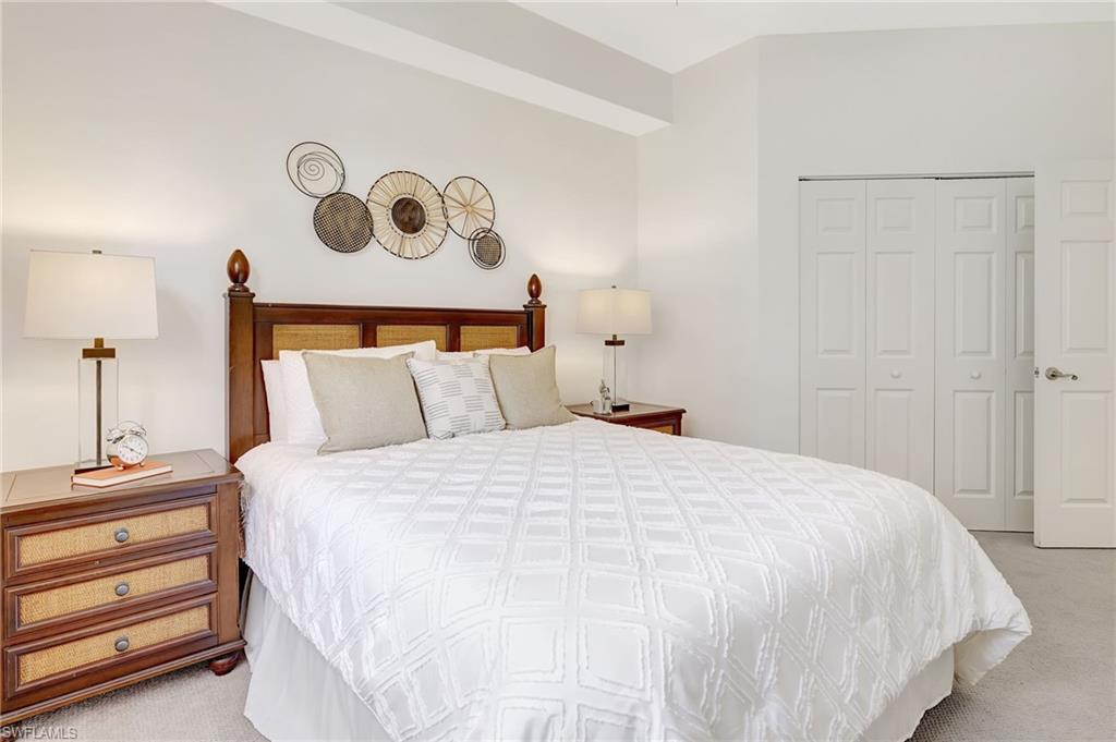 Bedroom with light carpet and a closet