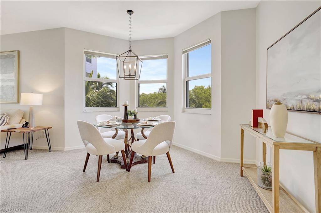 Dining area featuring a chandelier and carpet floors