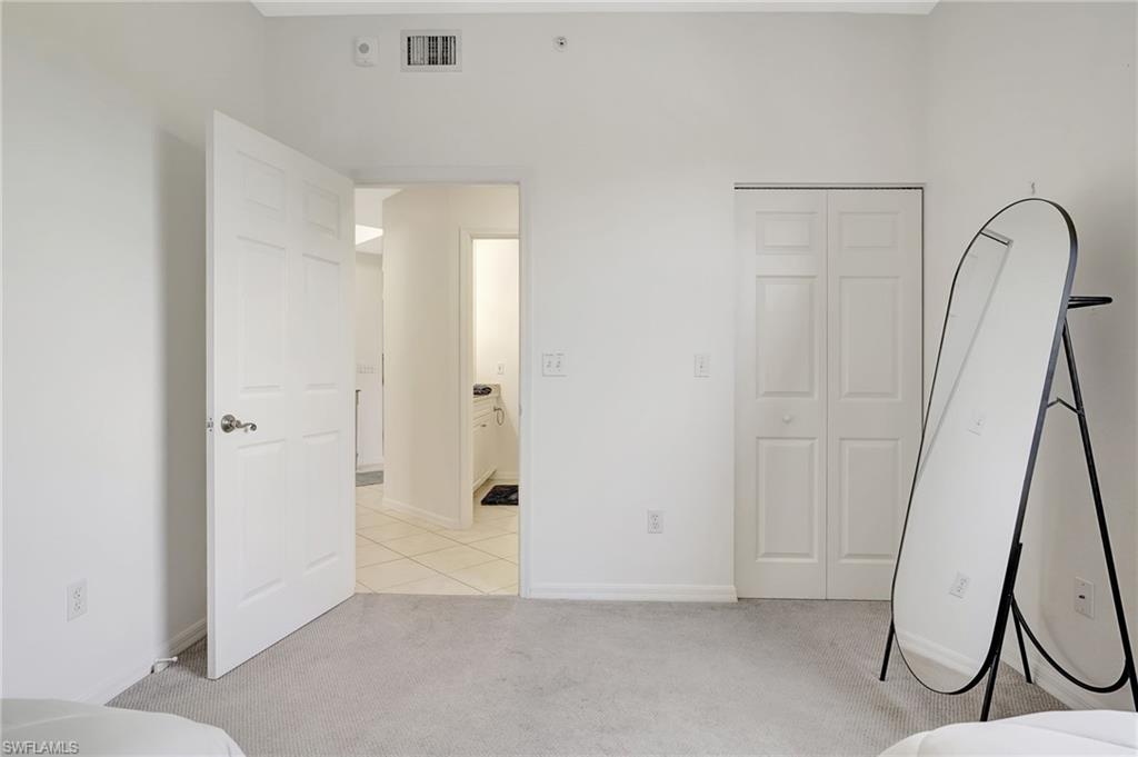 Unfurnished bedroom with a closet and light colored carpet