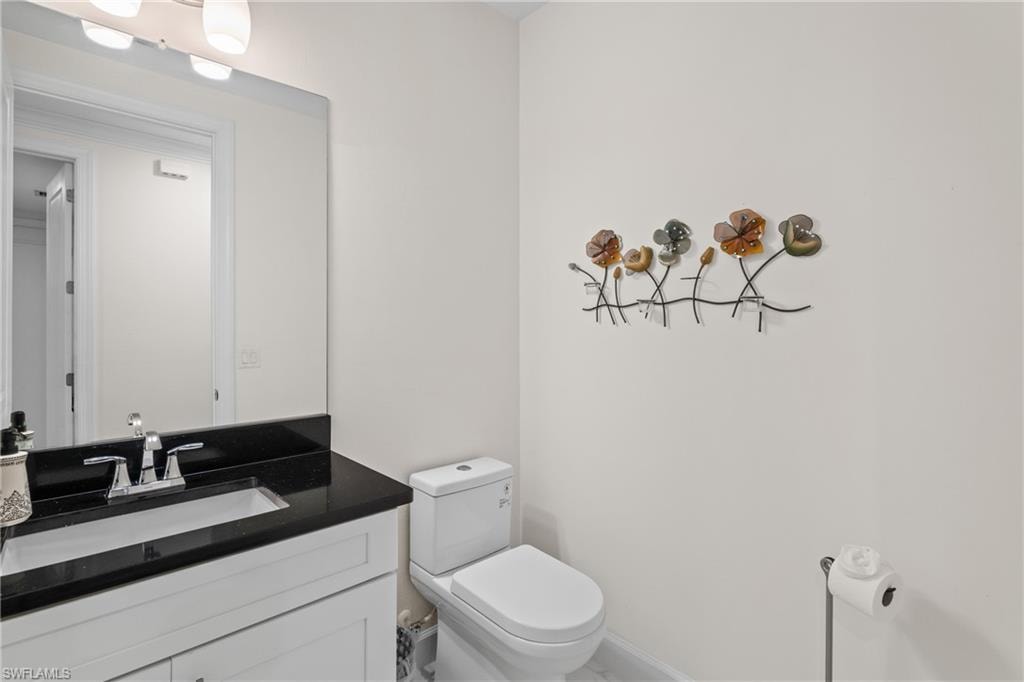 Bathroom featuring vanity and toilet