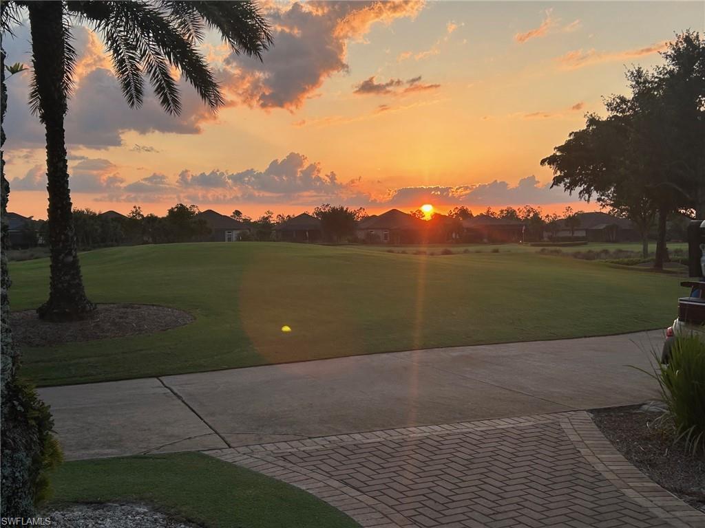 View of community featuring a lawn and view of golf course