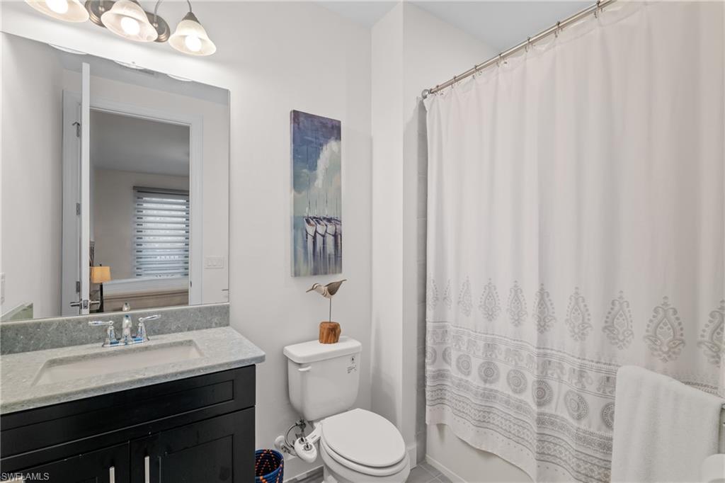 Full bath featuring vanity and shower / tub combo with curtain