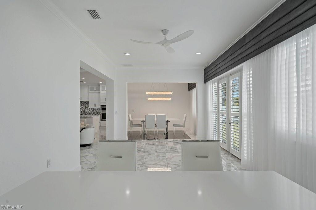 White interior featuring crown molding and recessed lighting
